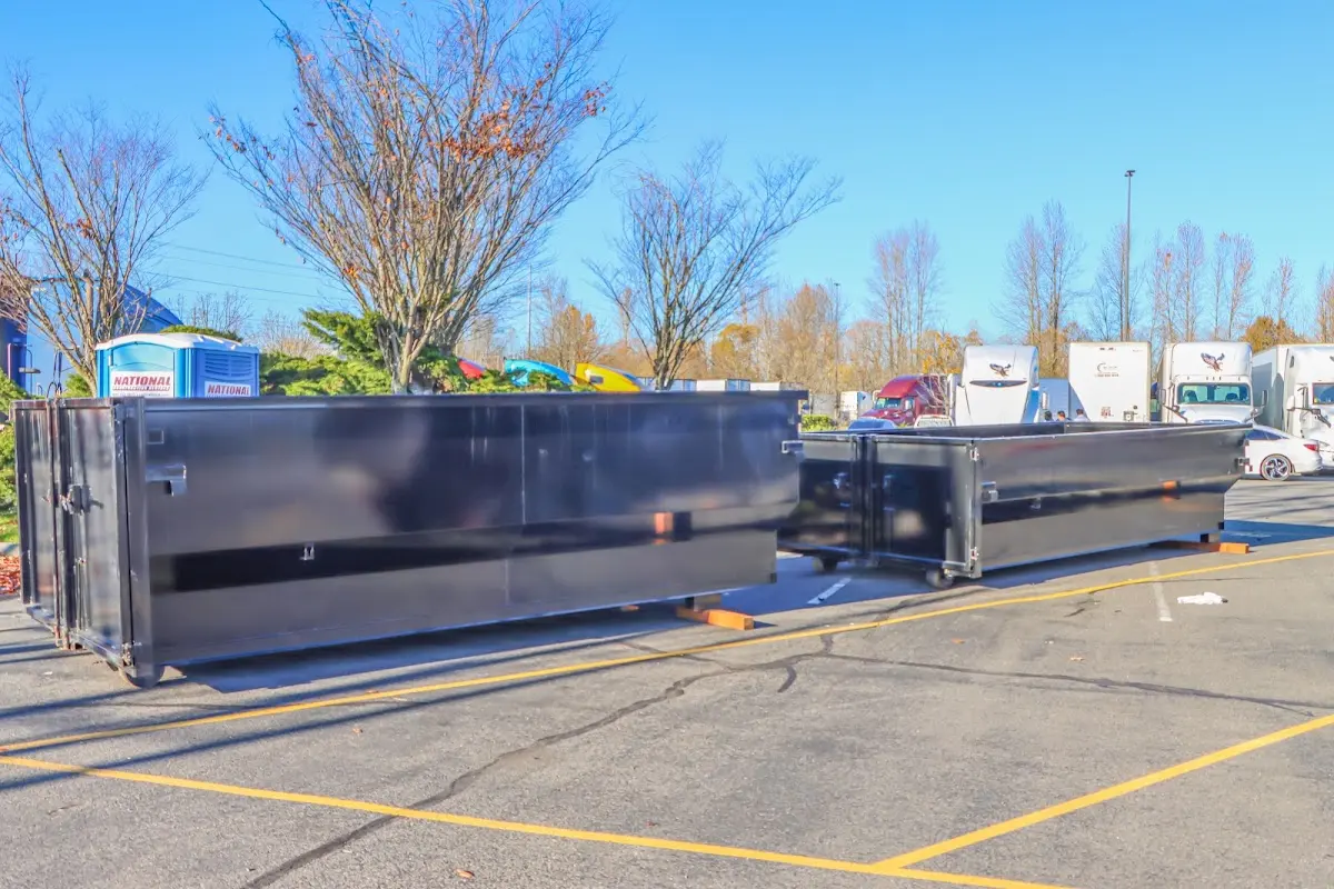 Professional dumpster rental service with roll-off container on residential driveway in Stonegate